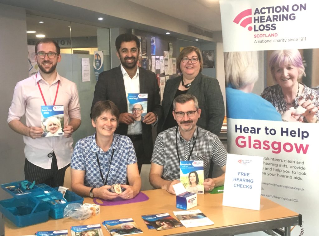 Back row: Thomas Denholm, Hear to Help Coordinator, Humza Yousaf MSP, Teri Devine, Director Action on Hearing Loss Scotland. Front row: Hear to Help Volunteers: Veronica Harty and Frankie Lydon