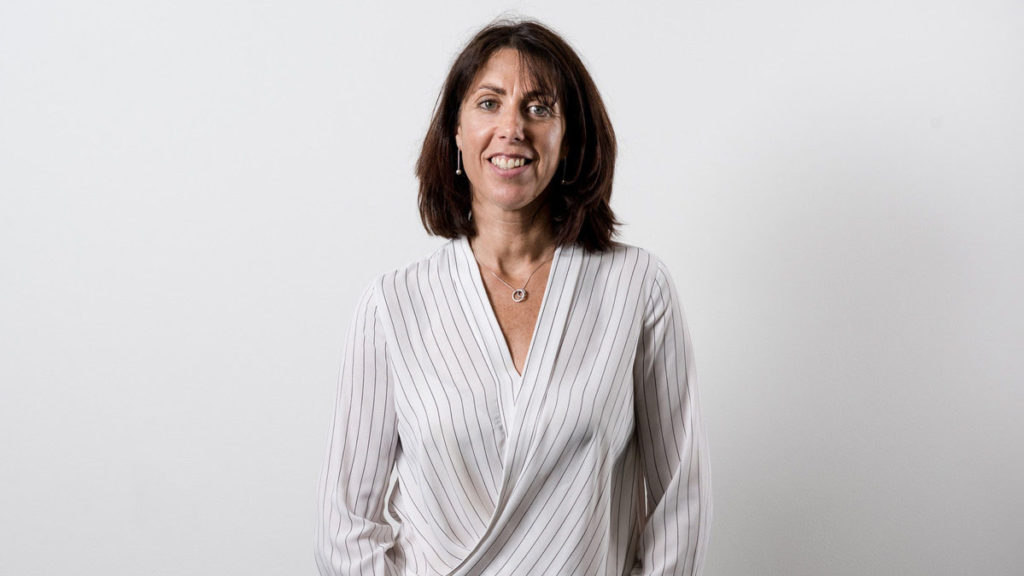 Louise wearing striped top and smiling