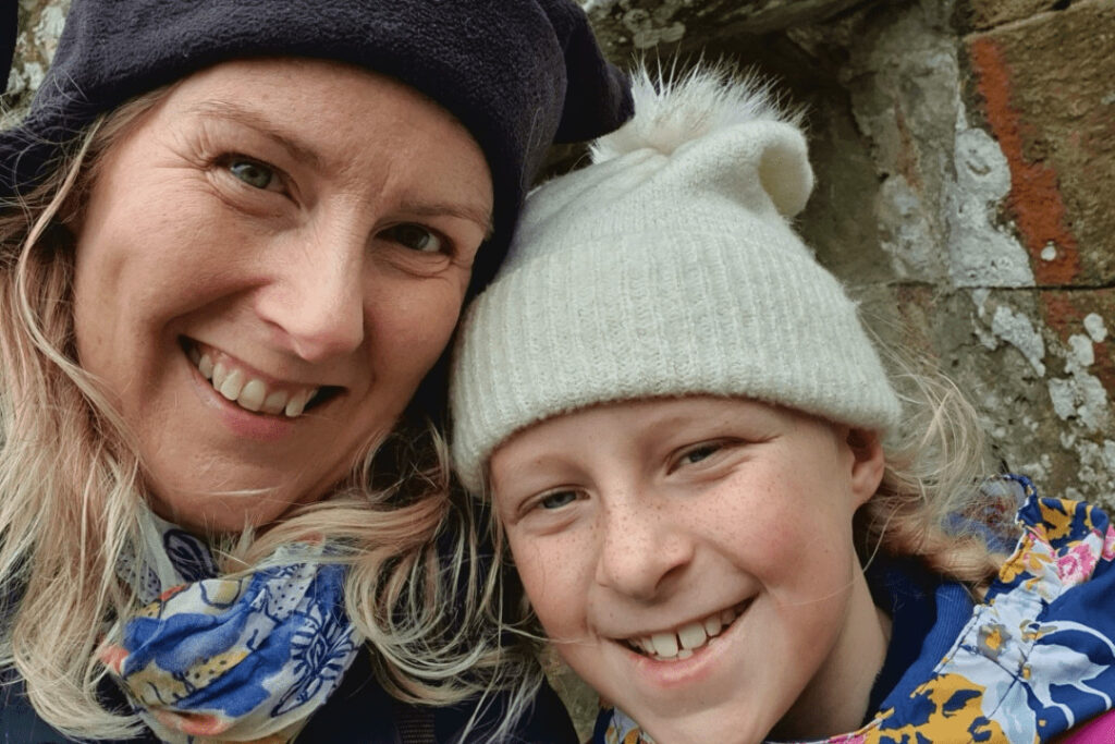 A woman and her daughter, smiling