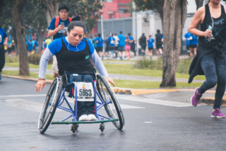 A woman in a wheelchair takes part in a race.