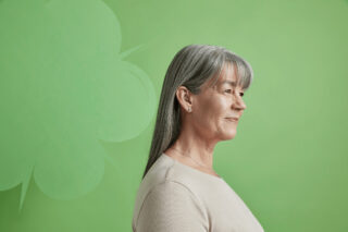 A woman standing in profile looking away from the camera