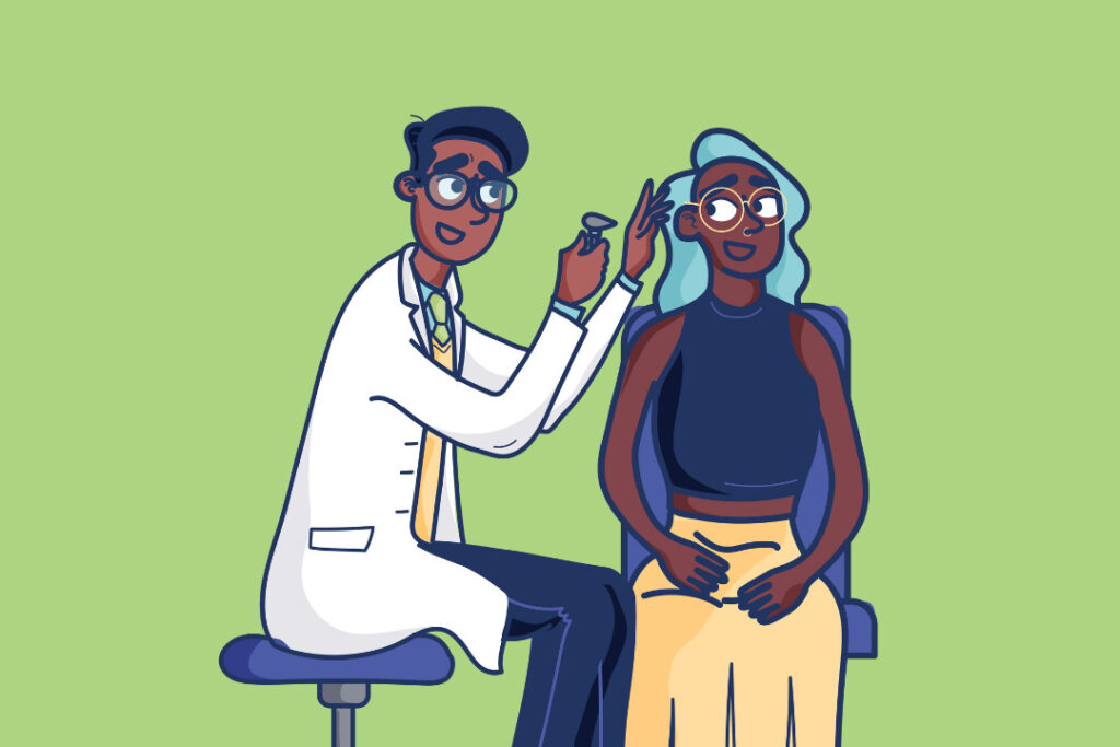 An audiologist sits on a stool and looks into a woman's ear. 