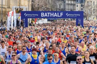 Runners of the Bath Half Marathon filling the streets of Bath.