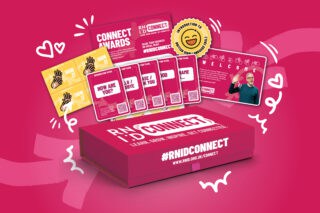 An RNID Connect pack: a pink box with #RNID Connect written on it. Illustrations of hearts, music icons and swirls emit from the box.