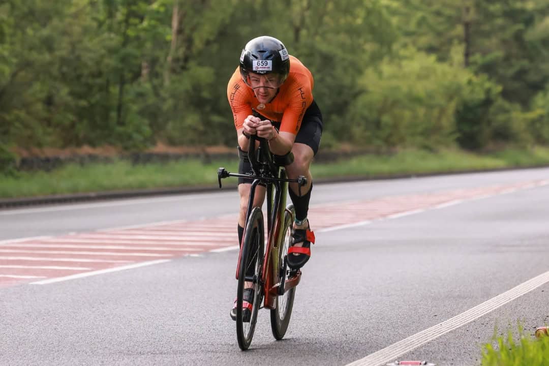 A man cycling on the road.