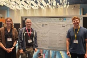 A group of people by a research poster at the ARO conference 2026