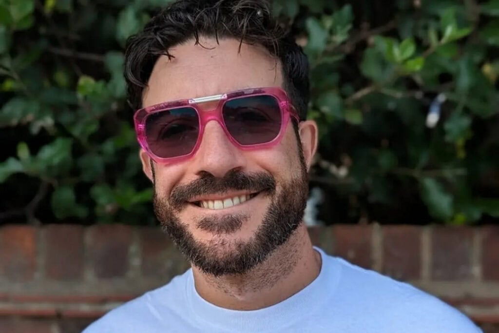 RNID storyteller, Ada, wears sunglasses and smiles. 