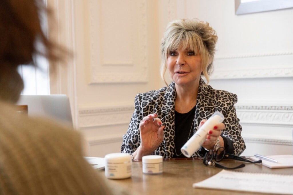 Lesley Reynolds sits behind a desk during a consultation at The Harley Street Clinic.