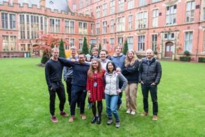 A group of researchers stand on the courtyard outside Sheffield University.