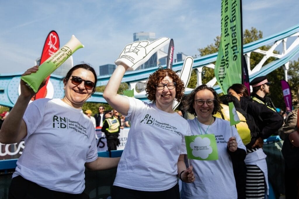 RNID staff cheer at London Marathon.
