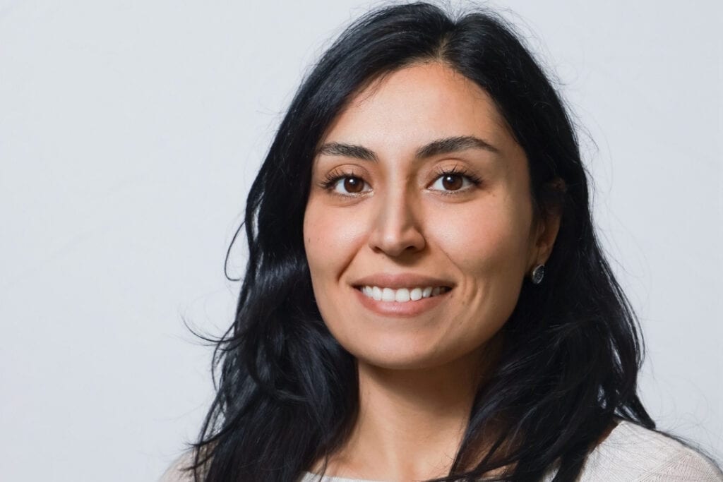 A headshot of Adele Moatti, who has long black hair and is smiling.