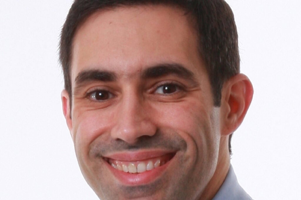 A headshot of Dr Daniel Llano smiling.