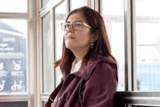 Storyteller Emily, sitting in a station waiting room